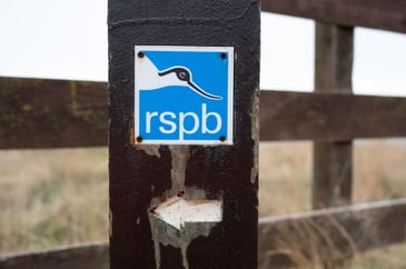 RSPB logo on fence post